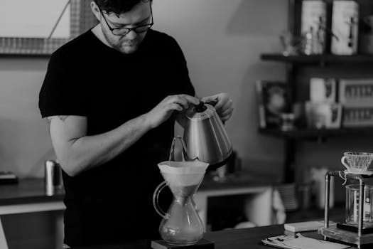 Man Pouring Liquid on Teapot